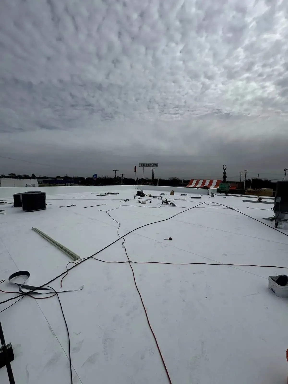 Wind-damaged commercial roof membrane